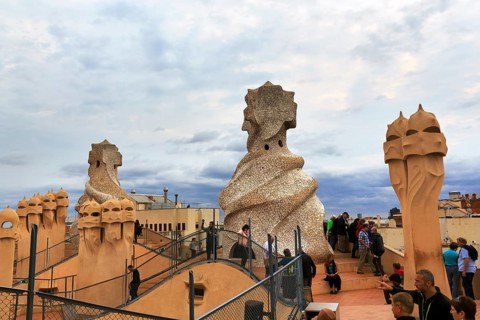 Tourists between artistically designed fireplaces on the large viewing platform, roof terrace in