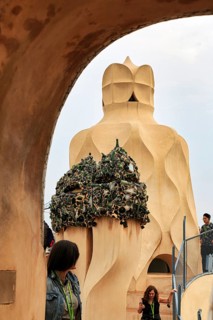 Tourists between artistically designed fireplaces on the roof terrace in the museum, Garden of the