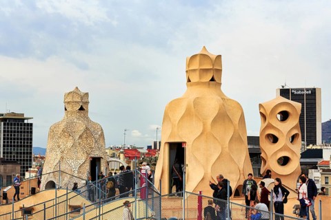 Tourist group between artistically designed fireplaces on the large viewing platform, roof terrace,