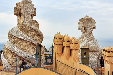 Tourists between artistically designed fireplaces on the large roof terrace, Garden of the