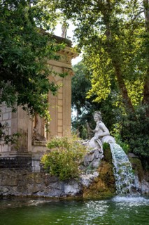 Temple of Aesculapius, Villa Borghese Lake. Water fountain statue detail. Rome, Italy, Europe