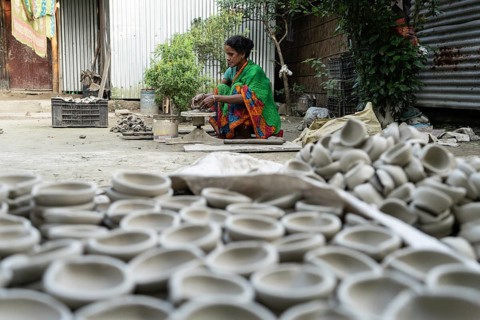 BARPETA, INDIA, NOVEMBER 7: A woman makes earthen lamps or Diyas at her residence ahead of the