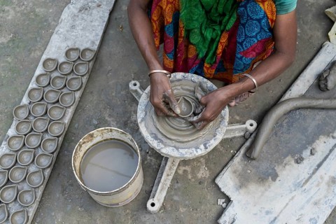 BARPETA, INDIA, NOVEMBER 7: A woman makes earthen lamps or Diyas at her residence ahead of the