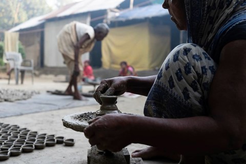 BARPETA, INDIA, NOVEMBER 7: A woman makes earthen lamps or Diyas at her residence ahead of the