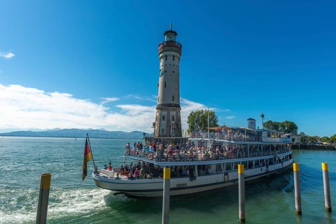Lindau at Lake Constance, entrance to the seaport, passenger ship with many holidaymakers, crowd,