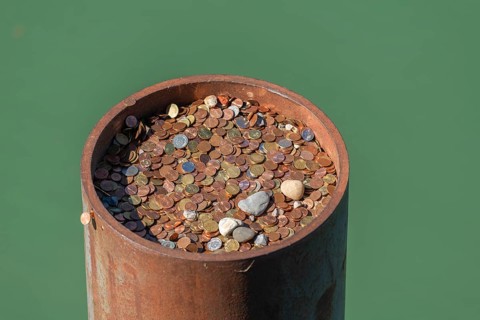 Lindau on Lake Constance, metal dolphin, many coins, currencies, superstition, bring good luck,
