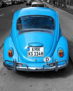 Rear of a light blue VW Volkswagen Beetle parked at the roadside, the number plate, licence plate,