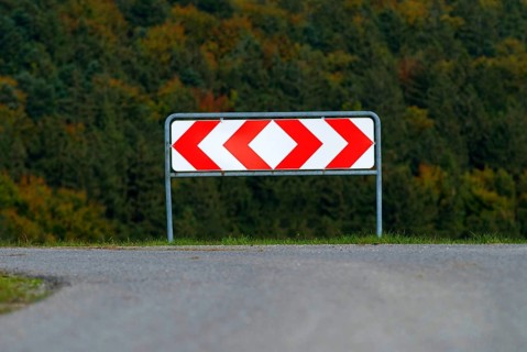Fork in the road in Germany, a sign shows the possible directions right and left, symbolising a
