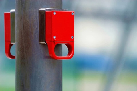 A bright red emergency brake on an underground escalator, unlabelled, Munich, Bavaria, Germany,
