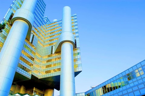 HVB Tower or Hypo-Haus, headquarters of Hypovereinsbank, Unicredit, in Arabellapark at dusk, blue
