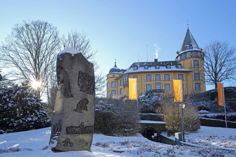 Genoveva Castle built 13th century backlit in winter with sculpture stone holder, stonemason,