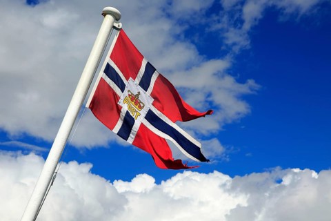 National flag flying on post ship Hurtigruten ferry, Norway, Europe