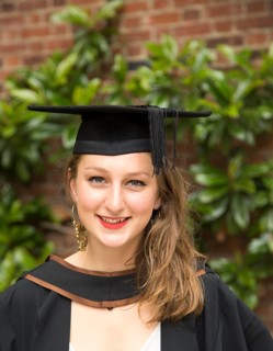 Head and shoulders portrait smiling young woman graduating, Goldsmiths, University of London,