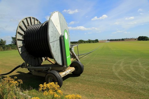 Rainstar E41 irrigation sprayer watering field of grass turf, Alderton, Suffolk, England, UK