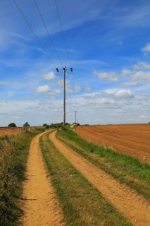 Rural electricity supply lines running across countryside, Alderton, Suffolk, England, United