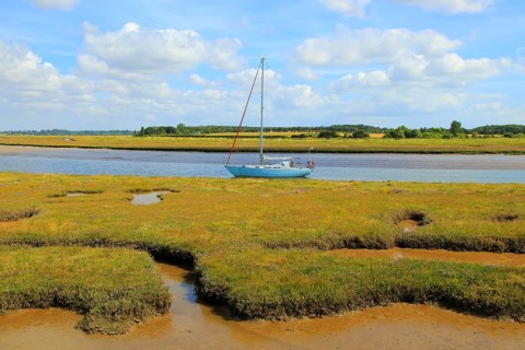 Butley Creek river landscape, Boyton, Suffolk, England, UK yacht at moorings