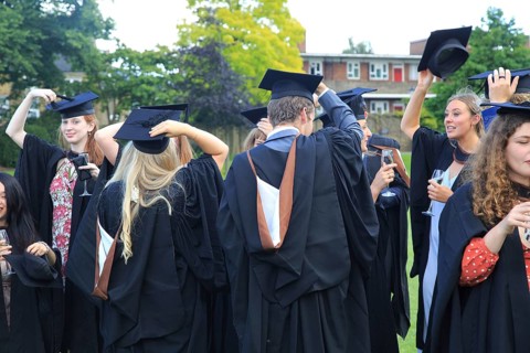 Graduates in gowns holding their mortarboards, Goldsmiths, University of London, England, UK