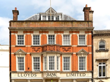 Red brick facade exterior of Lloyds Bank Limited, Devizes, Wiltshire, England, UK