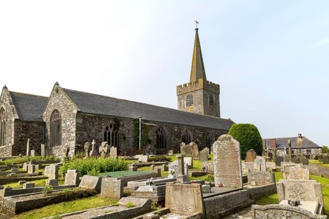 Spire and gravestones village parish church at St Keverne, Lizard Peninsula, Cornwall, England, UK