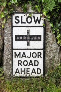 Old fashioned sign warning of major road junction ahead, St Keverne, Lizard peninsula, Cornwall,