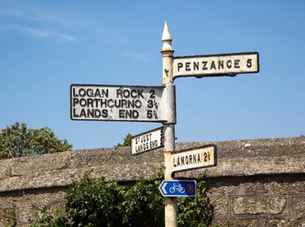 Old road sign distances and directions, St Buryan, Cornwall, England, UK