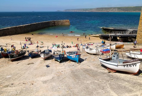 Fishing boats and breakwater in the harbour, Sennan Cove, Land's End, Cornwall, England, UK