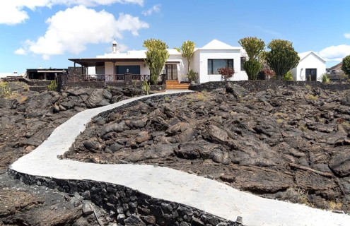 Garden path crossing solidified pahoehoe or ropey lava field, Tahiche, Lanzarote, Canary Islands,