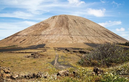 Volcano cone and black volcanic soil farmland, near Tinajo, Lanzarote, Canary Islands, Spain,