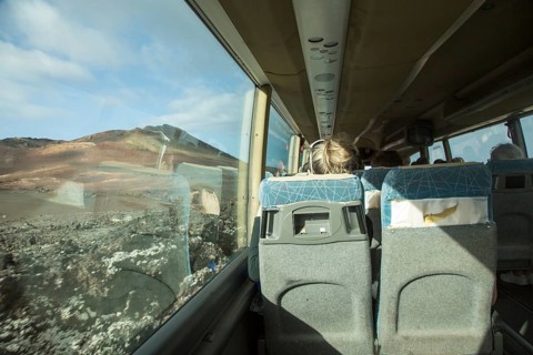 Tourists on tour bus on Ruta de Los Volcanes, Parque Nacional de Timanfaya, national park,