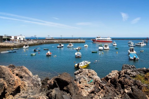 Harbour and ferry boat in the fishing village of Orzola, Lanzarote, Canary Islands, Spain, Europe
