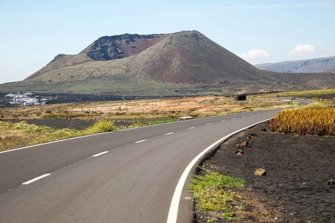 Road leading to cone of Mount Corona volcano and Ye village, Haria, Lanzarote, Canary Islands,
