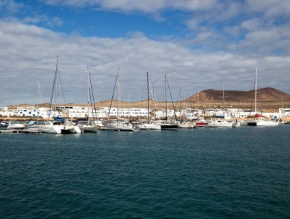 Yachts at moorings Caleta de Sebo harbour and village, La Isla Graciosa, Lanzarote, Canary Islands,