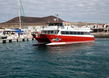 Tourist ferry boat Biosfera Express leaving the harbour Caleta de Sebo, La Isla Graciosa,