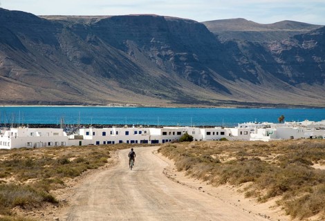 Cyclist dirt track leading to Caleta de Sebo village on Graciosa island, Lanzarote, Canary Islands,