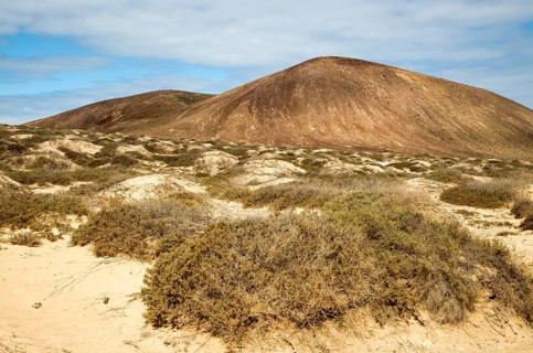 Inland sand dune landscape view towards Agujas Chicas volcano, La Isla Graciosa, Lanzarote, Canary