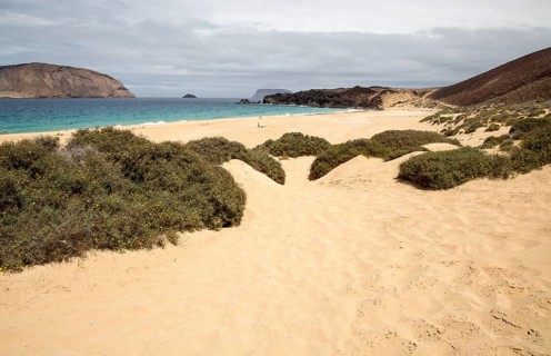 Montana Clara island nature reserve and sandy beach Playa de las Conchas, Graciosa island,