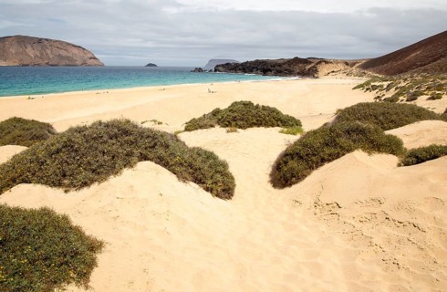 Montana Clara island nature reserve and sandy beach Playa de las Conchas, Graciosa island,