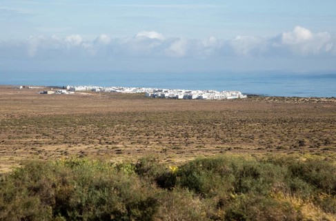 White cuboid buildings of coastal village La Caleta de Famara, Lanzarote, Canary islands, Spain,