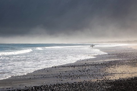Atlantic Ocean coast beach and waves with morning sea mist, Caleta de Famara, Lanzarote, Canary