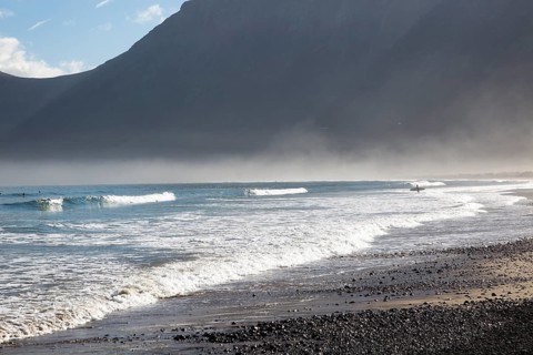 Atlantic Ocean coast beach and waves with morning sea mist, Caleta de Famara, Lanzarote, Canary