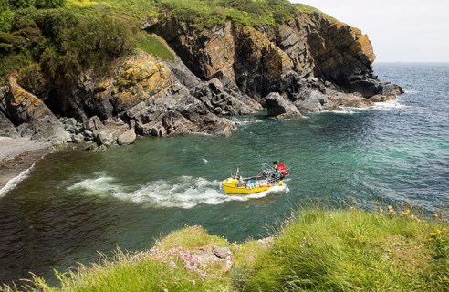 Fishing boat in narrow cove Cadgwith, Lizard peninsula, Cornwall, England, UK