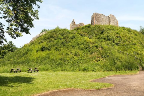 Norman motte and bailey castle with Victorian building ruin Eye, Suffolk, England, UK