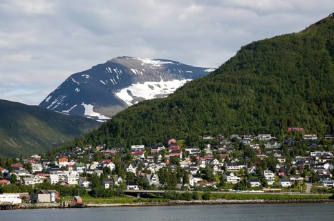 Suburban housing and landscape of snow on mountain side, Tromso, Norway, Europe