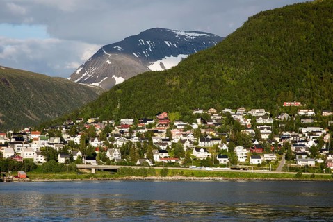 Suburban housing and landscape of snow on mountain side, Tromso, Norway, Europe