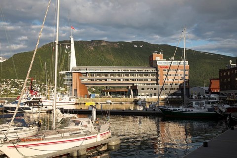 Modern architecture of Scandic Hotel and boats in harbour, city centre of Tromso, Norway, Europe