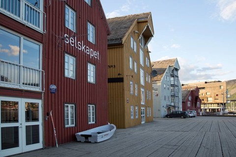 Waterside old warehouse wooden buildings harbour area, Tromso, Norway, Europe