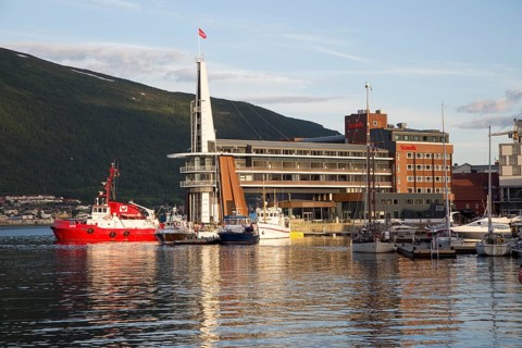 Modern architecture of Scandic Hotel and boats in harbour, city centre of Tromso, Norway, Europe