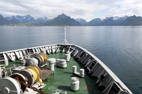 Hurtigruten ferry ship approaching the southern coast of Hinnoya Island, Nordland, northern Norway