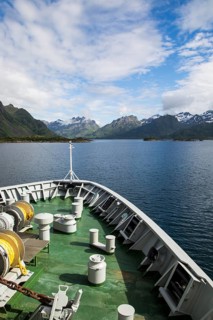Hurtigruten ferry ship approaching the southern coast of Hinnoya Island, Nordland, northern Norway