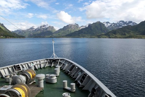 Hurtigruten ferry ship approaching the southern coast of Hinnoya Island, Nordland, northern Norway